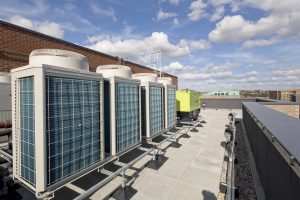 Image shows Air Source Heat Pump infrastructure on the roof of a building